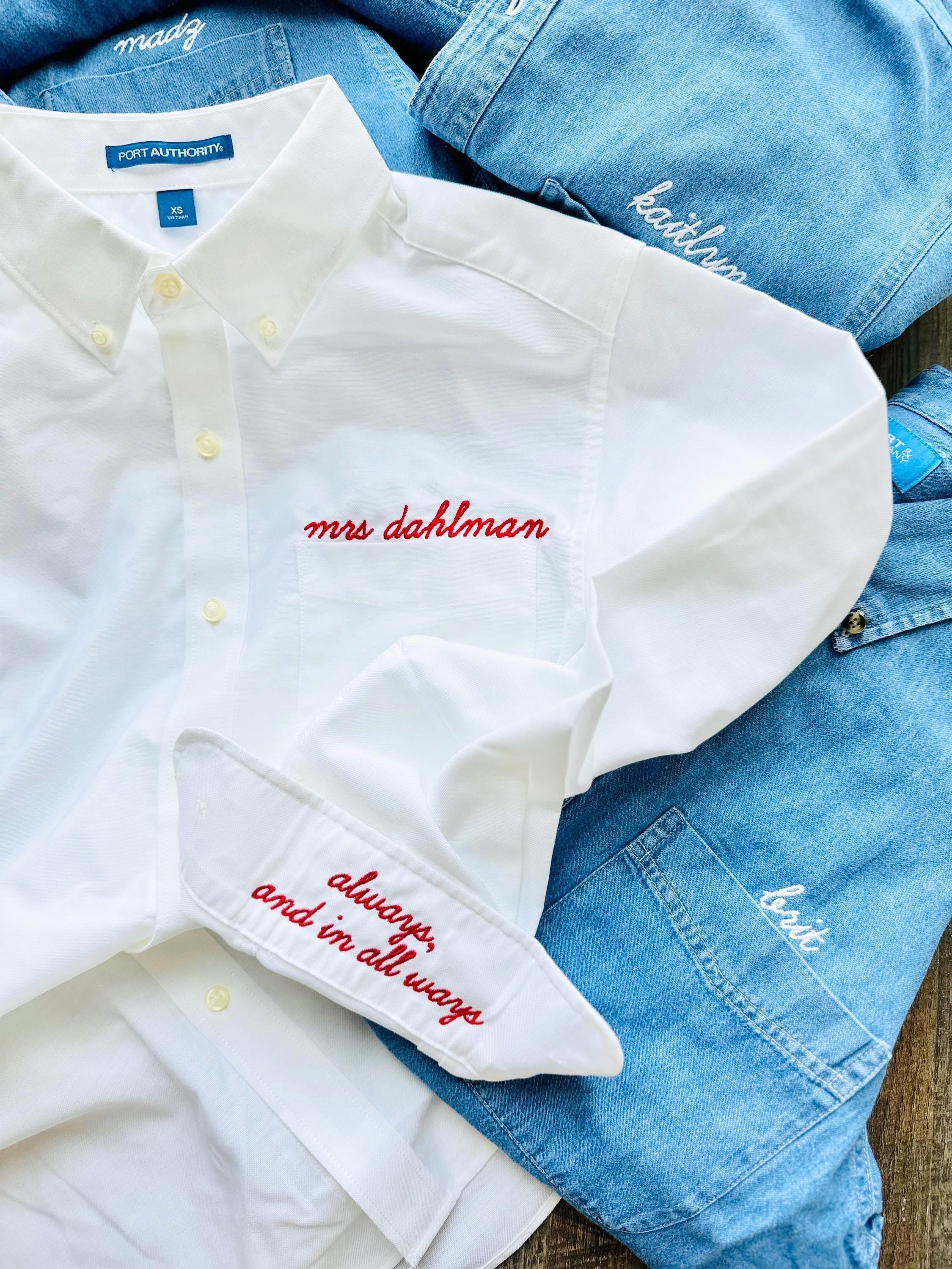 white button down shirt with red thread, Alison font. embroidery above the pocket and on the cuff. shown with denim button up shirts.
